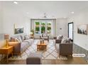 Bright living room with modern decor, including plush seating, stylish rug, and ample natural light at 371 Pratt Se Dr # 203, Atlanta, GA 30315