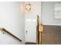 Bright entryway featuring hardwood floors, modern lighting, and a staircase with wood and iron railings at 2539 Hedgeway Cir, Kennesaw, GA 30144