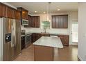 Bright kitchen featuring an island, stainless steel appliances, and warm wood floors at 2539 Hedgeway Cir, Kennesaw, GA 30144
