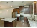 Modern kitchen with granite counters, stainless steel appliances, and dark wood cabinetry at 2539 Hedgeway Cir, Kennesaw, GA 30144