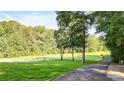 Landscaped yard with a long driveway leading to a gated entrance at 2269 E Cherokee Dr, Woodstock, GA 30188