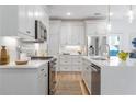 Modern kitchen with white cabinets, quartz countertops and island at 3315 Stillwood Ln, Atlanta, GA 30354