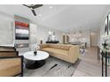 Open-concept living room flows into the dining area and features hardwood floors and a modern fireplace at 8200 Main St # 1206, Woodstock, GA 30188