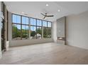 Bright living room featuring a modern fireplace, ceiling fan, and large windows with a scenic view at 8200 Main St # 1206, Woodstock, GA 30188