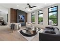 Inviting living room with a fireplace, accent wall, large windows, and stylish decor at 8200 Main S St # 1208, Woodstock, GA 30188