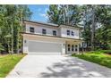 Stunning two-story white home with modern design, attached garage, and a spacious driveway at 2884 Thompson Cir, Decatur, GA 30034