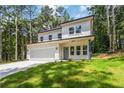 Beautiful two-story white home with a modern design, attached garage, and a spacious lawn at 2884 Thompson Cir, Decatur, GA 30034
