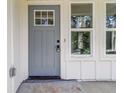 Charming home features a stylish gray front door with glass panels and sidelight windows for a welcoming entrance at 2884 Thompson Cir, Decatur, GA 30034