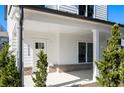 Inviting covered front porch with brick accents and white pillars on a sunny day at 3324 Springhaven Ave, Atlanta, GA 30354