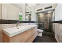 Modern bathroom features double sink vanity and a shower with glass enclosure, providing an elegant space at 1261 Lavista Rd # F-3, Atlanta, GA 30324