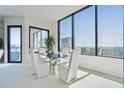 Modern dining area with floor-to-ceiling windows offering stunning city views at 2828 Peachtree Nw Rd # 2002, Atlanta, GA 30305