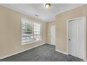 Bedroom featuring neutral-toned walls, carpet, and a window for natural light at 194 Riverstone Commons Cir, Canton, GA 30114
