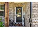 Close-up of a home's entryway with a decorated door and rustic wooden post at 160 Avery Landing Way, Canton, GA 30115