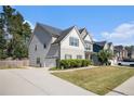 Two-story house with gray siding, stone accents, and a landscaped lawn at 2535 Grayton Loop, Villa Rica, GA 30180