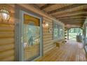 Charming porch featuring wood flooring, lighting, bench seating, and a decorative glass front door at 3208 Paddock Rd, Covington, GA 30014