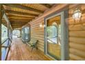 Inviting covered porch with a wooden bench and a clear view through the decorative glass front door at 3208 Paddock Rd, Covington, GA 30014