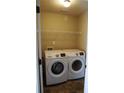 A functional laundry room features a Samsung washer and dryer and wire shelving at 2616 Holden Spring Dr, Dacula, GA 30019