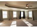 Spacious main bedroom boasts tray ceilings, large windows, and elegant curtains at 2616 Holden Spring Dr, Dacula, GA 30019
