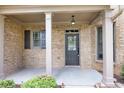 A charming front porch with brick facade and decorative columns at 2170 Indian Ivey Ln, Dacula, GA 30019