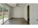 Bright bedroom featuring a ceiling fan, dark floors, and sliding door to the backyard at 2029 Memorial Dr # 34, Atlanta, GA 30317