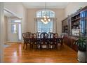 Formal dining room with hardwood floors, chandelier, wainscoting, and a large window with great natural light at 3240 Somerset Se Ct, Conyers, GA 30013