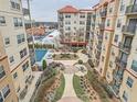 Community aerial view showcasing pool, landscaping, multiple-story buildings and parking lot at 230 E Ponce De Leon Ave # 210, Decatur, GA 30030