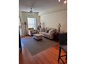 Inviting living room features neutral palette, ceiling fan, and an adjacent balcony door for natural light at 230 E Ponce De Leon Ave # 210, Decatur, GA 30030