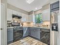 Modern kitchen with stainless steel appliances and blue gray cabinets at 3004 Hidden Lake Dr, Duluth, GA 30096