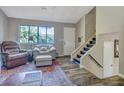 Bright living room with hardwood floors, comfortable seating, and access to stairs at 3004 Hidden Lake Dr, Duluth, GA 30096