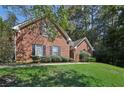 Brick house with a large front yard and lush landscaping at 710 Stonehenge Pl, Jonesboro, GA 30236