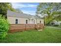 Nice side view of house with wooden deck and well-maintained lawn at 1159 Fair Sw St, Atlanta, GA 30314