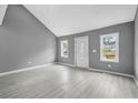 Bright living room with neutral paint, recessed lighting, and gray plank floors at 1159 Fair Sw St, Atlanta, GA 30314