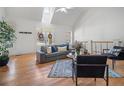 Sunlit living room featuring hardwood floors, vaulted ceiling, and a cozy seating area, perfect for relaxation at 216 Crescent Moon Way, Canton, GA 30114