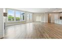 Spacious living room featuring hardwood floors, ample natural light, and neutral paint at 5225 Ginger Rose Ct, Cumming, GA 30028