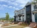 New townhomes with stylish exteriors, brick foundations, and scenic views of the surrounding landscape at 628 Skytop Dr # 158, Cumming, GA 30040