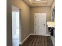 Inviting hallway with hardwood floors and modern decor leading to other rooms at 248 Persimmon Dr, Holly Springs, GA 30115