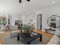 Bright open-concept living area with modern furnishings and hardwood flooring at 689 Dobbs Rd, Woodstock, GA 30188