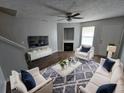 Cozy living room features stylish furniture, a fireplace, and wood-look flooring at 500 Mica Trce, South Fulton, GA 30349
