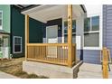 Quaint covered porch with a wood railing and number 401 at 1095 Tucker Ave # 401, Atlanta, GA 30310