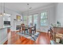 Bright dining area with hardwood floors, fireplace, and access to balcony with natural light at 3621 Vinings Slope Se # 3202, Atlanta, GA 30339