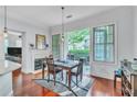 Cozy dining area with hardwood floors, fireplace, and access to the outdoor patio at 3621 Vinings Slope Se # 3202, Atlanta, GA 30339
