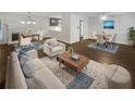Bright, open-plan living room with modern furnishings and dark wood flooring at 720 Smithstone Se Rd, Marietta, GA 30067