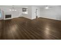 Open-concept living space with dark wood flooring and a classic fireplace at 720 Smithstone Se Rd, Marietta, GA 30067