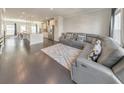 Open-concept living room with modern gray sofa, hardwood floors, and abundant natural light at 550 Whitlox Nw Rd, Atlanta, GA 30318