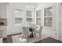 Bright dining area with large windows, plantation shutters, and a modern light fixture, great for Gathering meals at 330 Wagon Way, Alpharetta, GA 30009