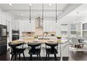 This large kitchen with island barstool seating flows into the adjacent dining area, offering a seamless entertaining space at 330 Wagon Way, Alpharetta, GA 30009