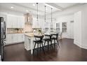 Bright kitchen features a large island, pendant lighting, and stainless steel appliances, ideal for modern living at 330 Wagon Way, Alpharetta, GA 30009
