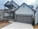 Two-story house with gray siding, stone accents, and a two-car garage at 366 Boundless Ln, Canton, GA 30114