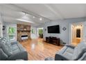 Bright living room features a stone fireplace, hardwood floors, and a comfortable seating area at 626 Dover St, Marietta, GA 30066
