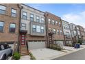 Charming exterior view of townhomes with brick and siding and attached garages at 1017 Brandsford Nw St, Atlanta, GA 30318